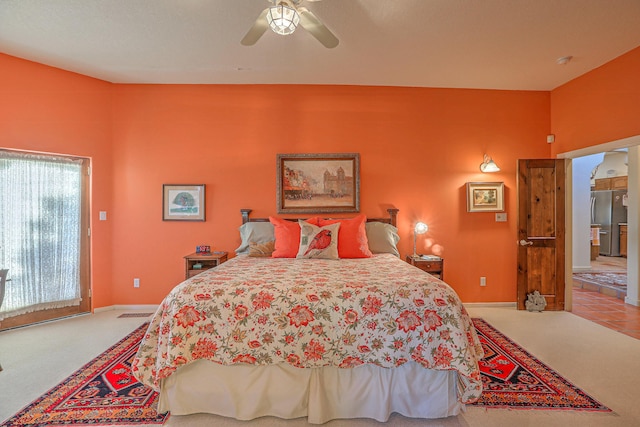 carpeted bedroom with baseboards, access to outside, ceiling fan, and freestanding refrigerator