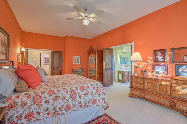 bedroom with carpet flooring, connected bathroom, and ceiling fan