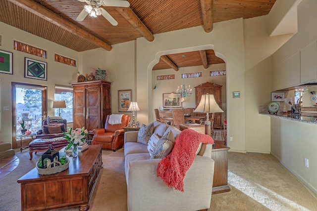 living room with beam ceiling, wood ceiling, arched walkways, and ceiling fan