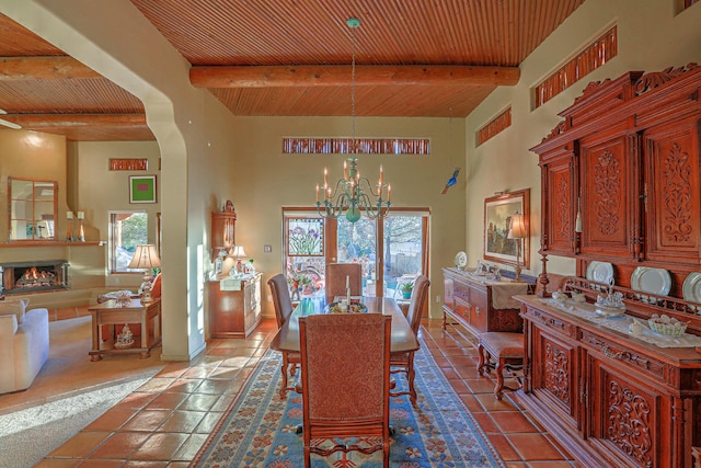 tiled dining space with a chandelier, beamed ceiling, wooden ceiling, and arched walkways