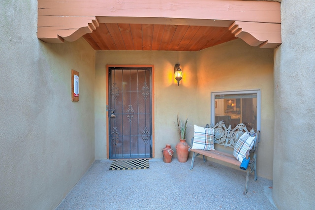 doorway to property featuring stucco siding