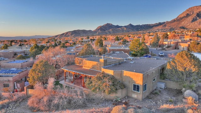 aerial view at dusk with a mountain view and a residential view