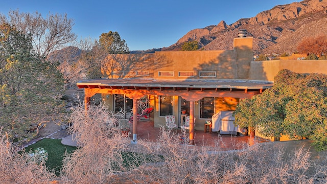 rear view of house featuring a patio and a mountain view