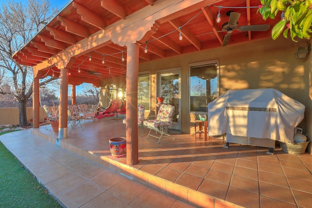 view of patio / terrace with a grill and fence