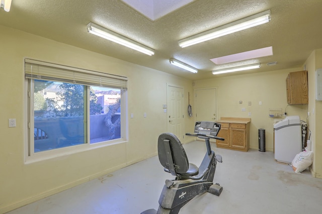 exercise room featuring a textured ceiling