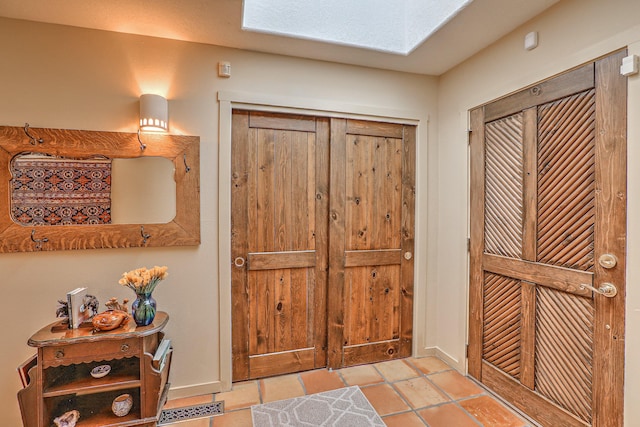 tiled foyer featuring visible vents and baseboards