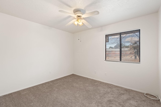 carpeted empty room featuring baseboards, a textured ceiling, and ceiling fan