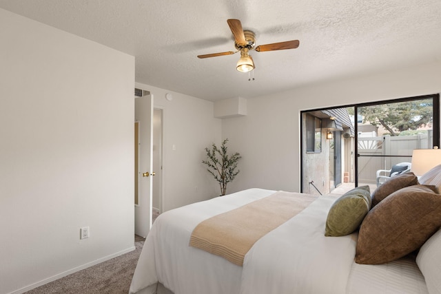 bedroom featuring a textured ceiling, ceiling fan, carpet flooring, and access to exterior