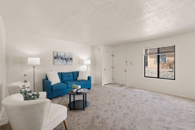 living area with carpet, baseboards, and a textured ceiling