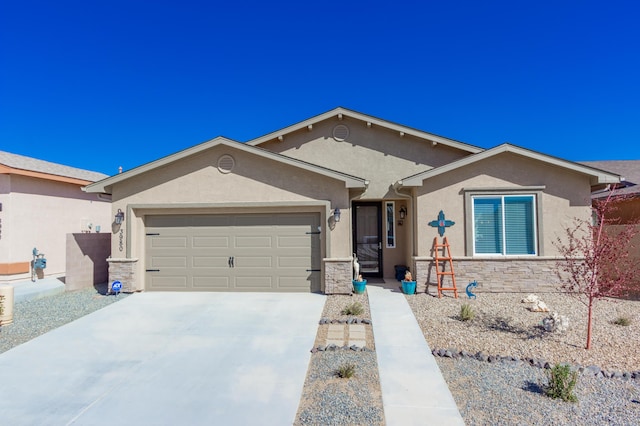 ranch-style home featuring concrete driveway, a garage, stone siding, and stucco siding