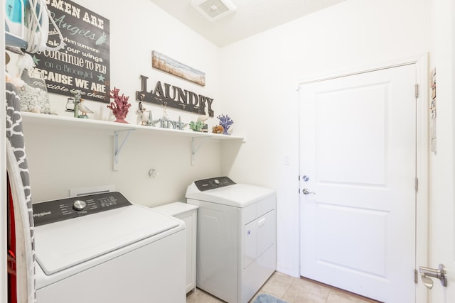 laundry room with light tile patterned floors, laundry area, and washer and dryer