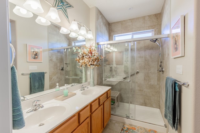 full bathroom with tile patterned flooring, a shower stall, and a sink