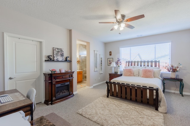 bedroom with baseboards, a textured ceiling, and light carpet