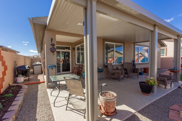 view of patio featuring fence and grilling area