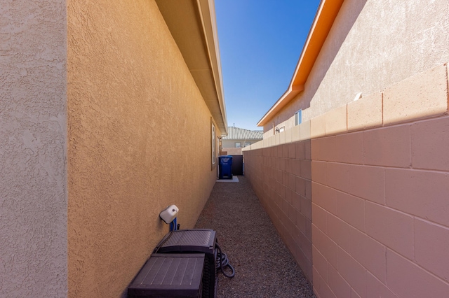 view of property exterior featuring stucco siding and fence