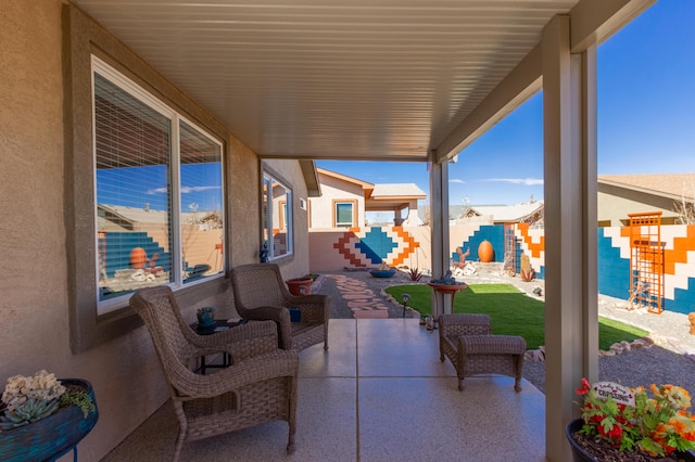 view of patio with an outdoor living space and fence