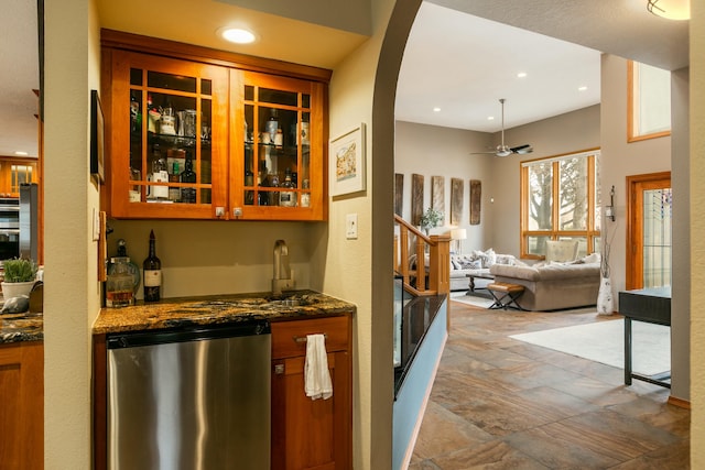 bar featuring indoor wet bar, fridge, recessed lighting, and a sink