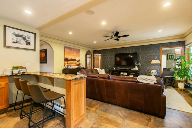 living area with arched walkways, recessed lighting, crown molding, and ceiling fan