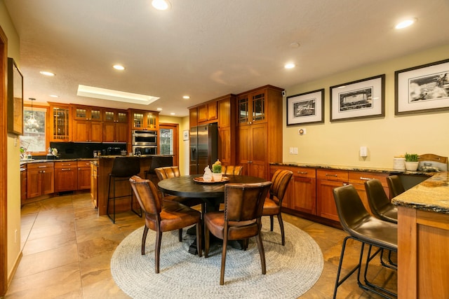 dining room with recessed lighting and a skylight