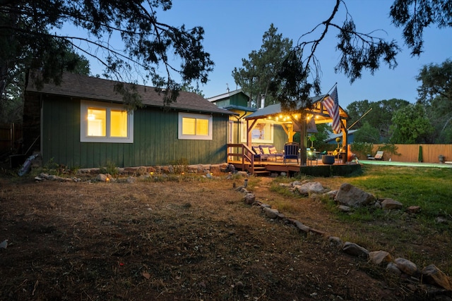 rear view of property featuring fence