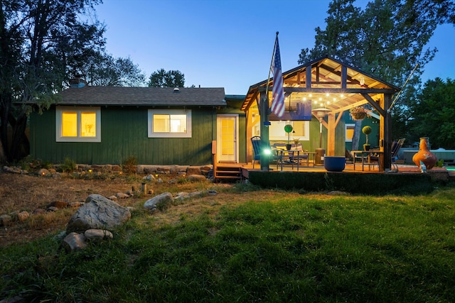 rear view of property featuring a yard