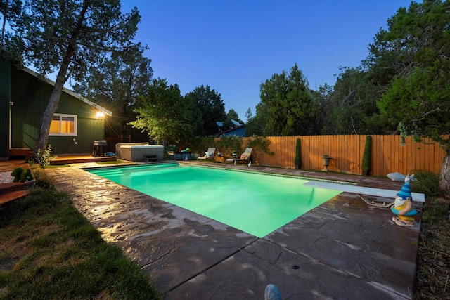 view of pool with a fenced in pool, a hot tub, a fenced backyard, a patio area, and a diving board