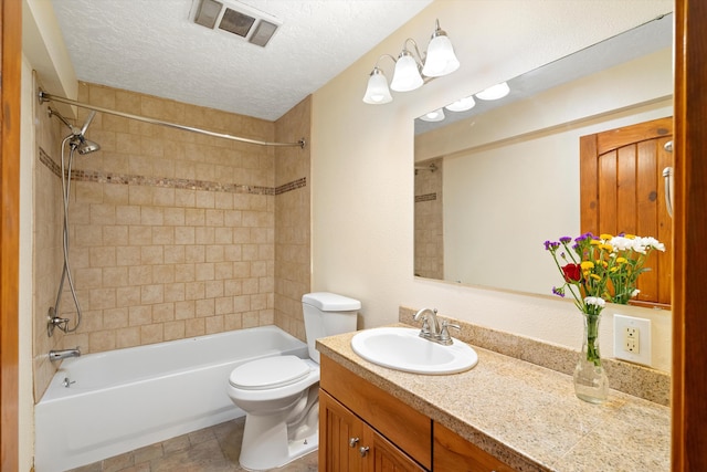 bathroom with visible vents, toilet, a textured ceiling, shower / tub combination, and vanity