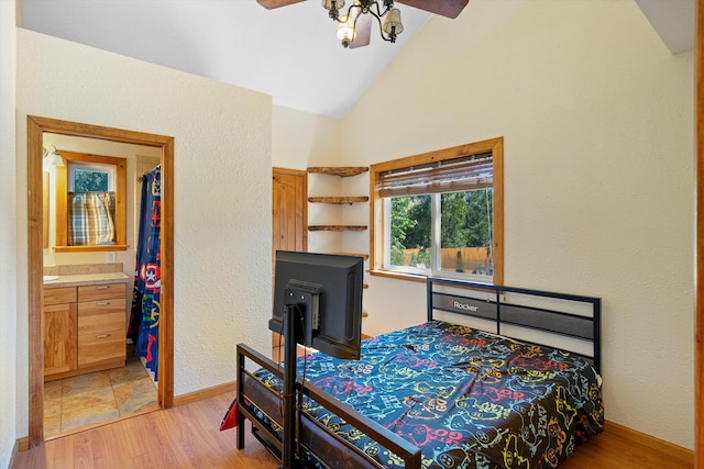 bedroom featuring lofted ceiling, baseboards, and light wood finished floors