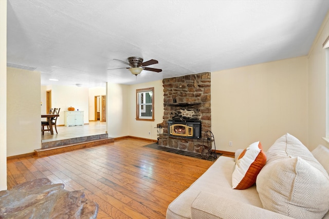 living room with hardwood / wood-style flooring, baseboards, and ceiling fan