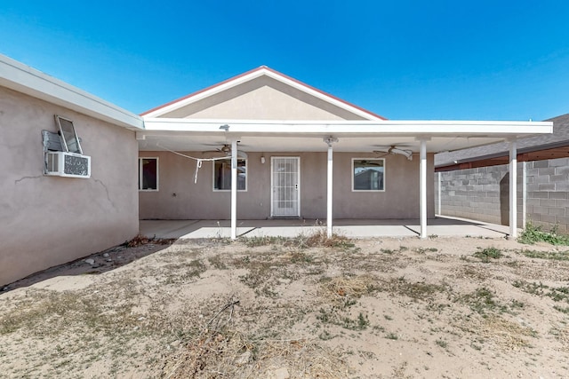 back of house with ceiling fan, a patio area, and stucco siding