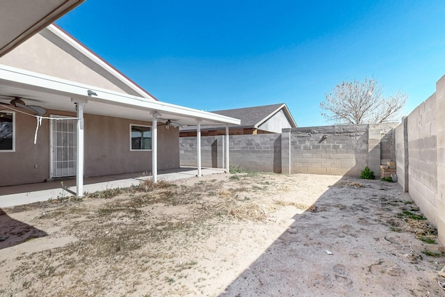 view of yard with a fenced backyard, a patio, and a ceiling fan