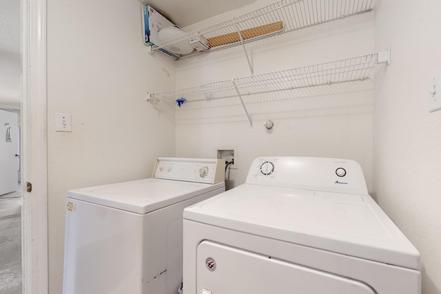 laundry room with separate washer and dryer and laundry area