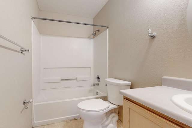 full bathroom featuring tile patterned flooring, tub / shower combination, toilet, a textured wall, and vanity