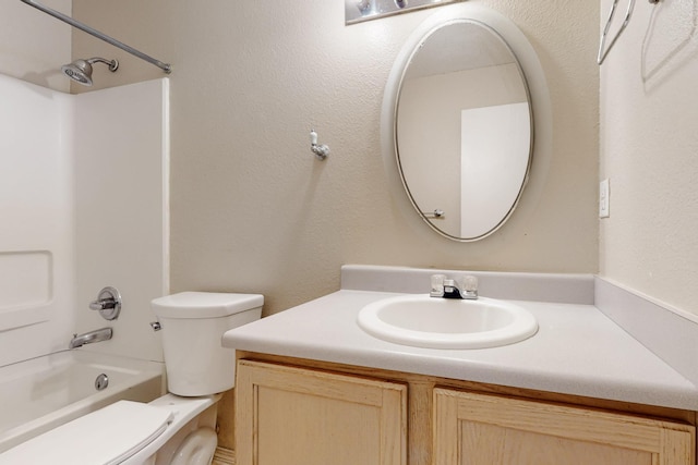 full bath featuring shower / bath combination, toilet, vanity, and a textured wall