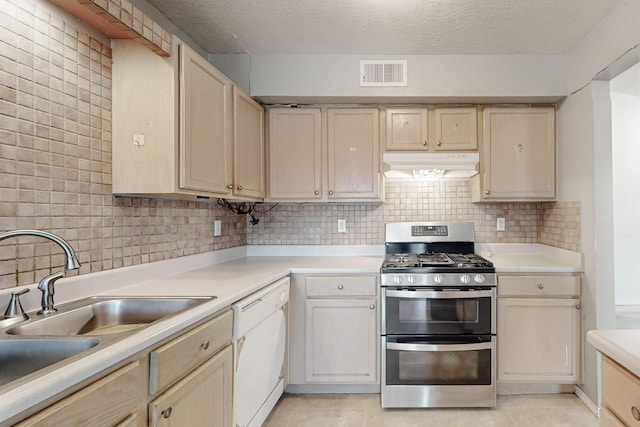 kitchen with visible vents, range with two ovens, under cabinet range hood, dishwasher, and backsplash