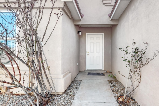 doorway to property with stucco siding