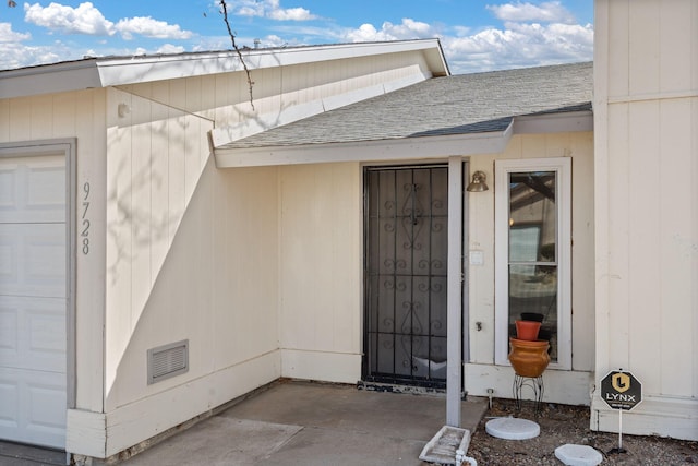 doorway to property featuring visible vents and roof with shingles