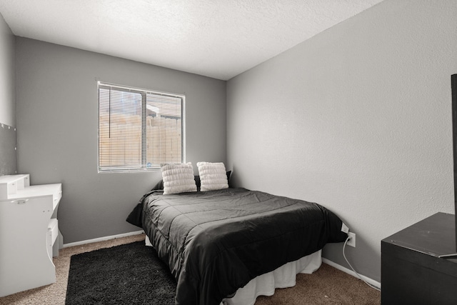 carpeted bedroom with a textured ceiling, baseboards, and a textured wall