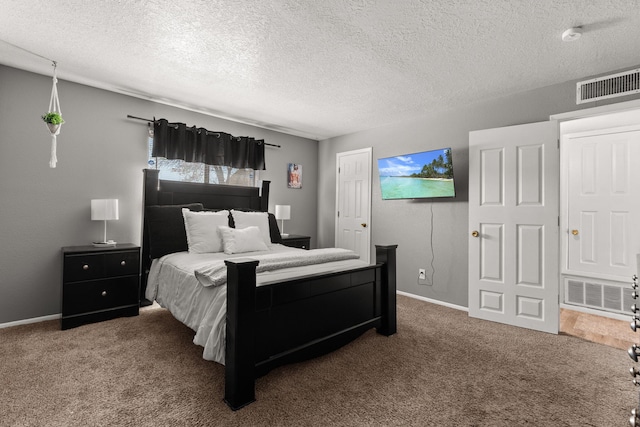 bedroom featuring visible vents, carpet floors, a textured ceiling, and baseboards