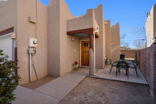 view of patio with outdoor dining area and fence