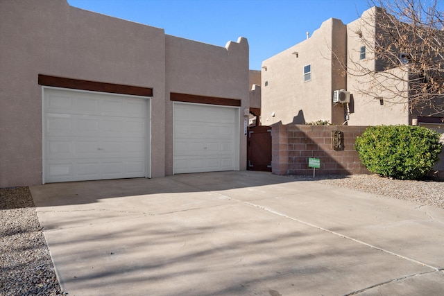 view of side of home featuring stucco siding and driveway