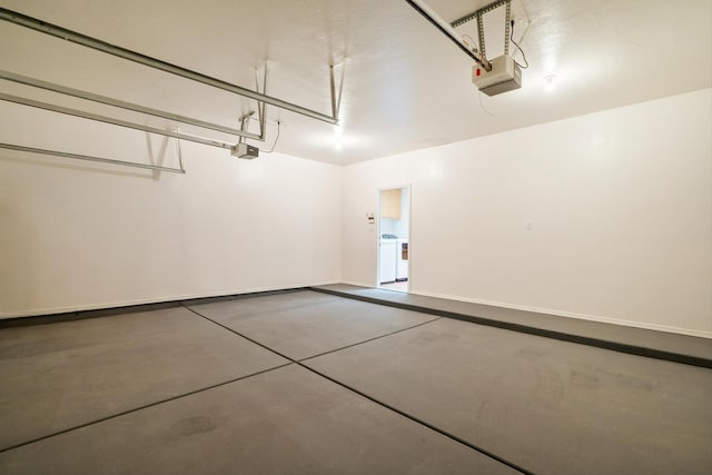 garage featuring washer / dryer and a garage door opener