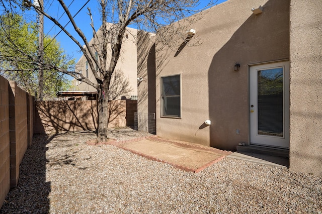 exterior space featuring a patio, a fenced backyard, and stucco siding