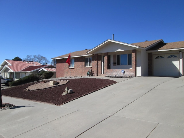 ranch-style house featuring brick siding, an attached garage, and concrete driveway