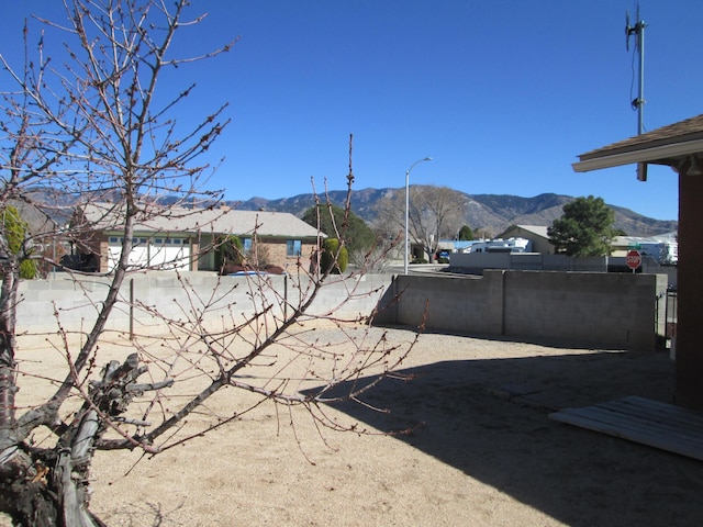 view of yard with a mountain view and fence