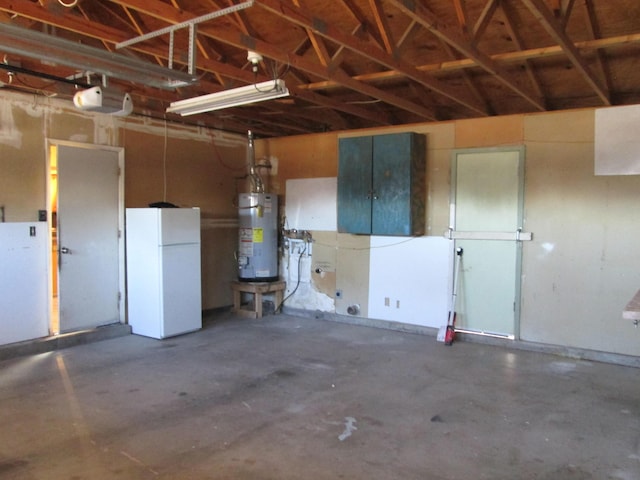 garage with gas water heater and freestanding refrigerator