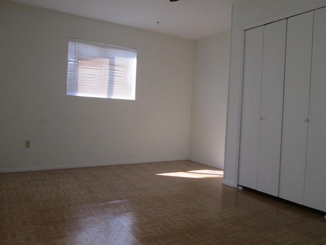 unfurnished bedroom featuring a closet and baseboards