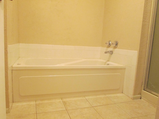 full bathroom with tile patterned floors, a garden tub, and a shower stall