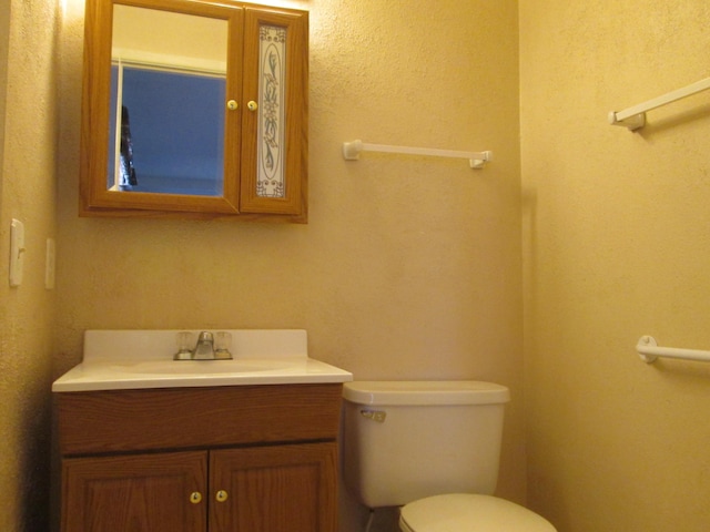 bathroom with toilet and vanity