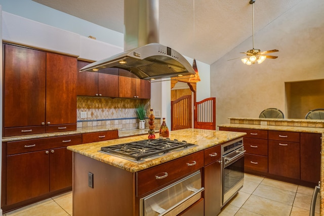 kitchen with tasteful backsplash, a center island, ceiling fan, appliances with stainless steel finishes, and island exhaust hood